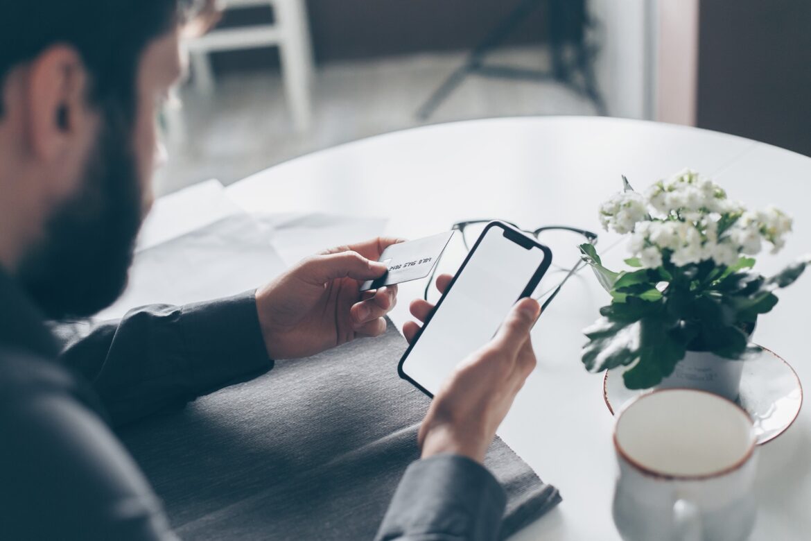 man using payment software on his phone